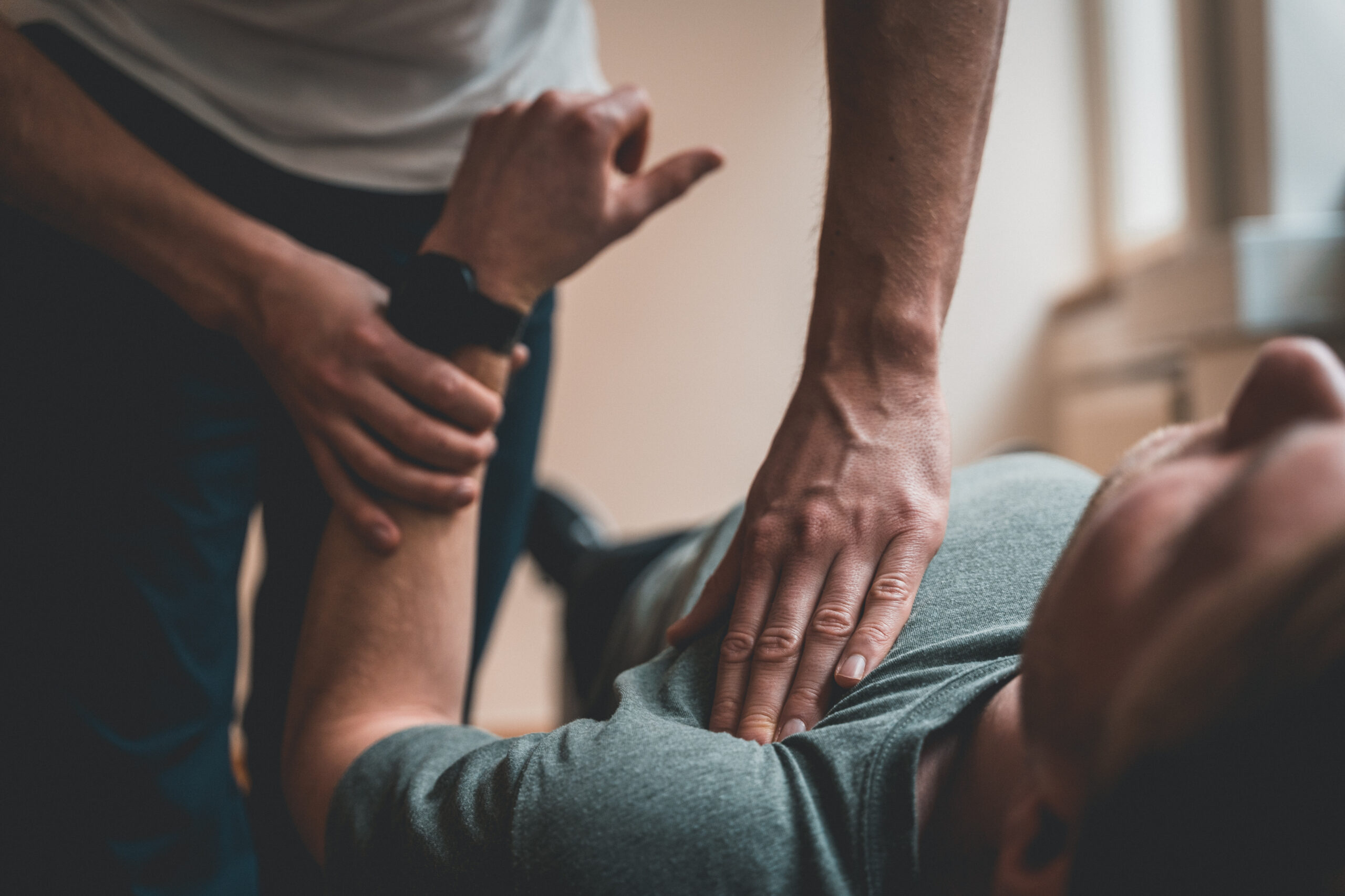 Physiotherapist treating patient for various physical ailments