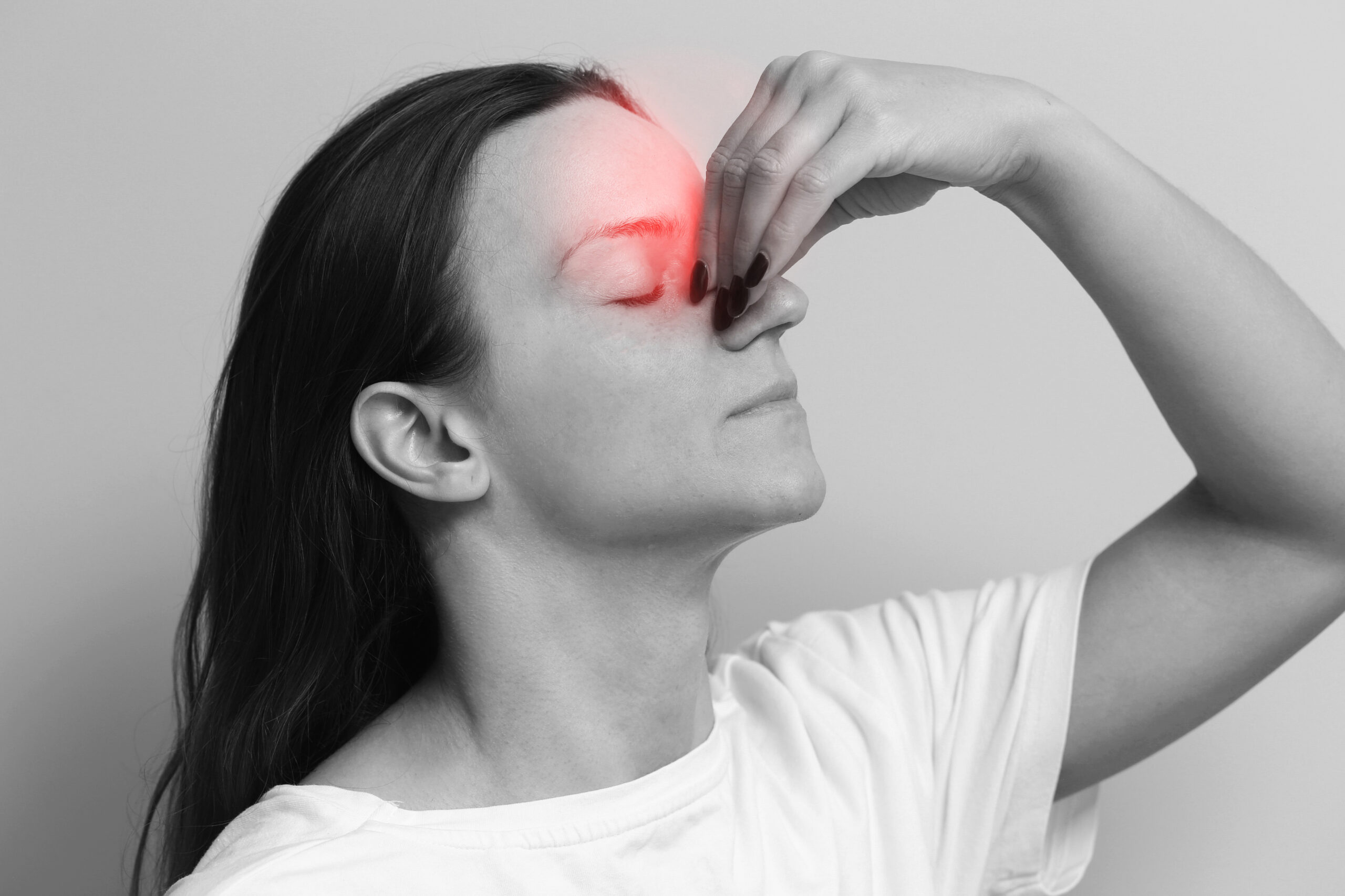 Woman holding her nose. Painful facial expression. Sinus pressure and discomfort. Chronic sinus issue background. Headache and tension. Living with sinus pain. Health problem face reaction.