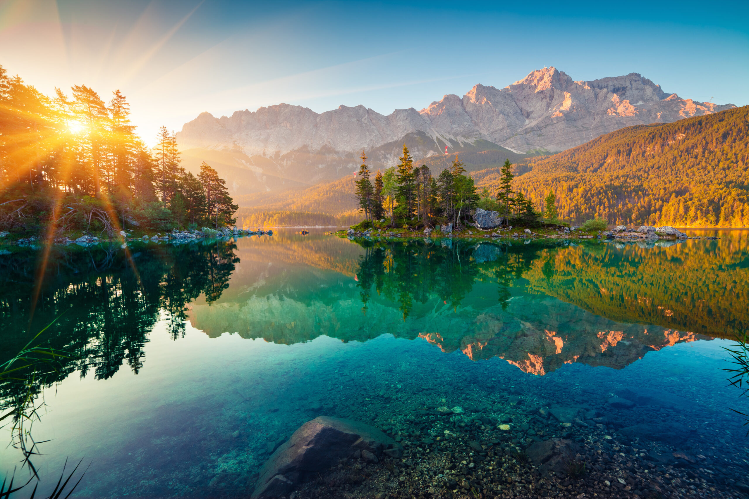 Impressive summer sunrise on Eibsee lake with Zugspitze mountain